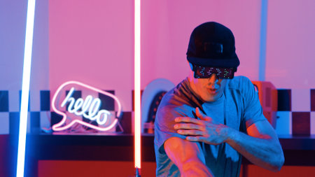 Skilled break dancer wearing fancy glasses with glowing effect while caucasian performer with casual...