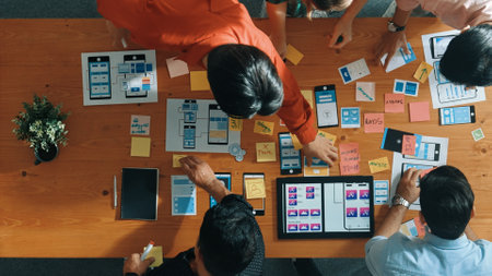 Top down view of business team writing idea on sticky note while planing for Ux Ui design for mobile phone interface. Group of creative designer working on wireframe prototype design. Convocation.の写真素材