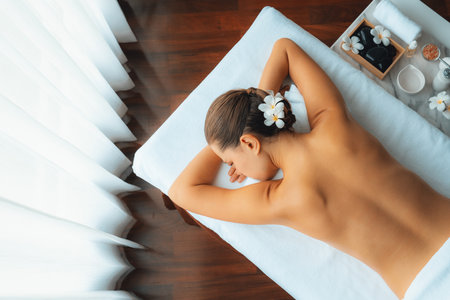 Panorama top view woman customer enjoying relaxing anti-stress spa massage and pampering with beauty skin recreation leisure in day light ambient salon spa at luxury resort or hotel. Quiescentの写真素材