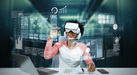 Girl using laptop and augmented glasses connecting metaverse while doing homework at table with book...