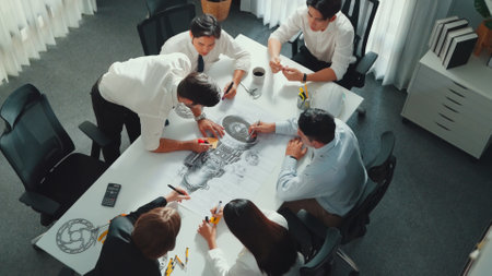 Top view of professional engineer showing and talking about turbine engine design. Aerial view of...