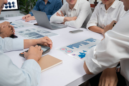 Diverse corporate audit team or company bookkeeper and accountant consultant calculate account expenses and income budget for tax refunds using calculators in busy workspace. Prudentの写真素材