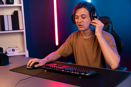 Host channel of gaming smart streamer playing online game to be winner, wearing headphone with...