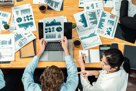 Top view diverse group of business analyst team analyzing financial data report paper on meeting...