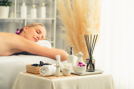Caucasian woman customer enjoying relaxing anti-stress spa massage and pampering with beauty skin recreation leisure in day light ambient salon spa at luxury resort or hotel. Quiescentの写真素材