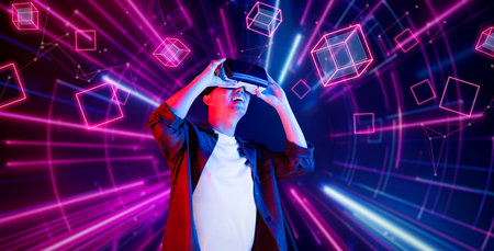 African man excited about exploring in metaverse while wearing VR headset and standing at glowing...