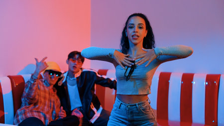 Hispanic dancer perform movement while diverse friend sitting and dancing together. Happy...