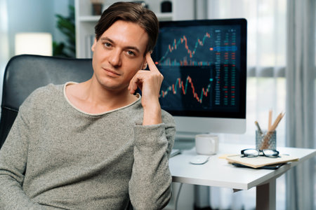 Smart business trader in casual looking at camera against value dynamic increased stock exchange...