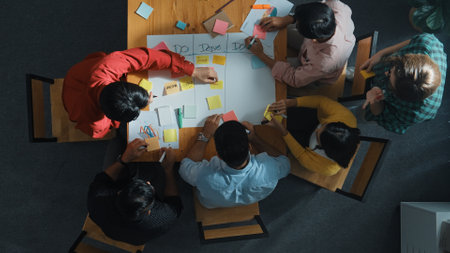 Top view of people writing and making scrum task board while writing marketing and planning strategy...