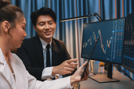 Businesswoman holding tablet on dynamic stock exchange statistic online showing to partners to...