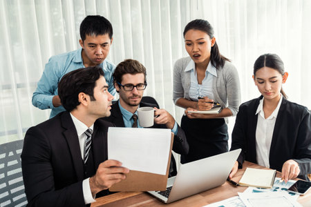 Diverse of business people from various ethnic group working in modern office environment. Productive and multi ethnic office workers engage in discussion for strategic business marketing. Meticulousの写真素材