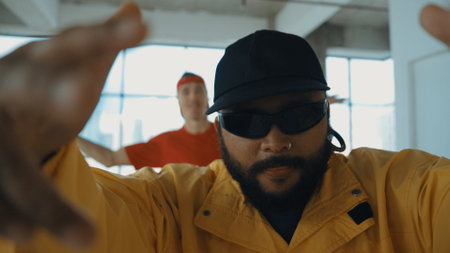 Closeup portrait of multicultural hipster dancing while looking at camera. Attractive break dancer...