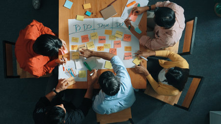 Top view of people writing and making scrum task board while writing marketing and planning strategy at colorful sticky notes. Smart team manage work performance by using kanaban board. Convocation.の写真素材