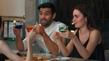 Couple or group friends discussing lifestyle and drinking cocktail gin tonic, blue hawaii,...