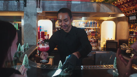 Focused on mixed punch cocktail Christmas theme garnishing with burning cinnamon and star anise by...