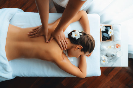 Panorama top view woman customer enjoying relaxing anti-stress spa massage and pampering with beauty skin recreation leisure in day light ambient salon spa at luxury resort or hotel. Quiescentの写真素材