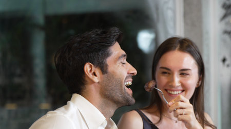 Portrait closeup smart face man having dinner of crispy and grill meat dish with couple and friend...