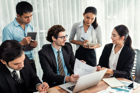Diverse of business people from various ethnic group working in modern office environment. Productive and multi ethnic office workers engage in discussion for strategic business marketing. Meticulousの写真素材