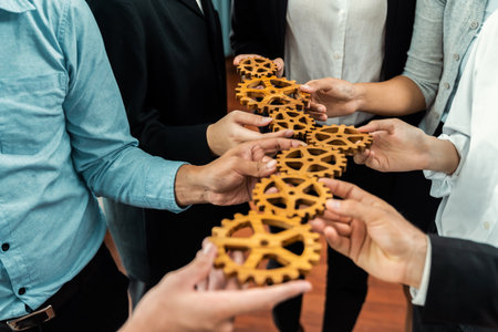 Group of multiracial business people joining gear wheels together as effective unity and productive teamwork concept. Efficient system business team process for solution solving. Meticulousの写真素材