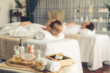 Aromatherapy massage on daylight ambiance or spa salon composition setup with focus decor and spa accessories on blur woman enjoying blissful aroma spa massage in resort or hotel background. Quiescentの写真素材