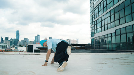 Stylish caucasian dancing man performing break dance at skyscraper. Portrait image of young happy man practicing street dance performance choreographer in modern urban city. Paris style. Hiphop.の写真素材