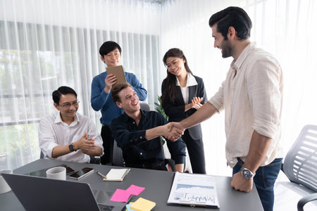 Diverse group of office employee worker shake hand after making agreement on strategic business marketing meeting. Teamwork and positive attitude create productive and supportive workplace. Prudentの写真素材