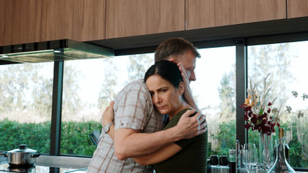 Lovely old marriage couple talking about bad event, news or problem in kitchen. Male senior console sad wife. Adorable grandfather and grandmother have strong relationship and family. Divergence.の写真素材