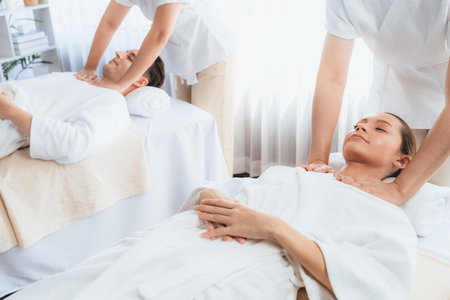 Caucasian couple customer enjoying relaxing anti-stress spa massage and pampering with beauty skin recreation leisure in day light ambient salon spa at luxury resort or hotel. Quiescentの写真素材
