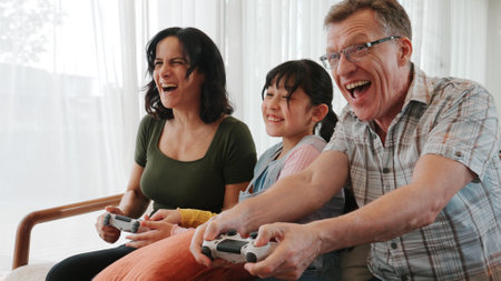 Grandfather, grandmother and granddaughter play console game as hobby. Old senior use technology...