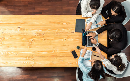 Panorama top view diverse group of business analyst team analyzing financial data report paper on meeting table. Chart and graph dashboard by business intelligence analysis. Meticulousの写真素材