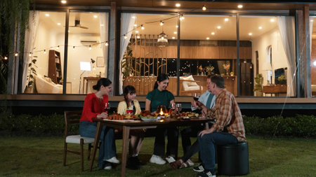 Family gather celebrate holiday. Parents, grandparents and girl together to talk and have dinner party food. Outdoor activity for spending time with multigeneration cross generation gap. Divergence.の写真素材