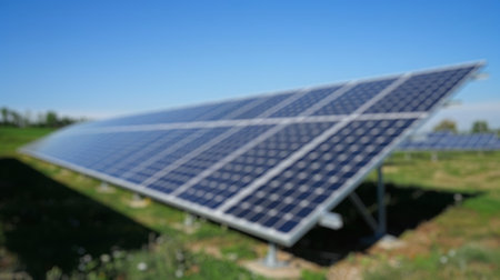 Blur background of solar station panel in the field with blue sky. Clean electrical energy. Ecology. Top view of solar panel absorb sunlight and generate electricity. Technology innovation. Spate.の写真素材