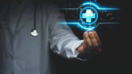 Close up of skilled doctor holding and picking light bulb with medical cross. Smart general practitioner accessing medical data and representing creative innovation of healthcare system. Remedial.の写真素材