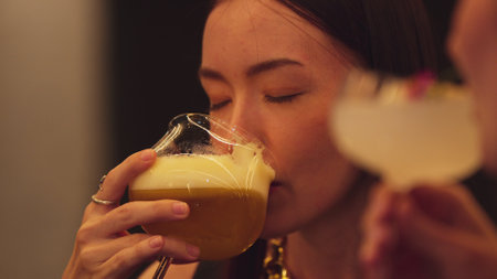 Enjoy drinking beautiful woman mixed vodka cocktails at luxurious counter bar toasting with friends scene capture essence nightlife luxury with special highlighting refreshment friendship. Vinosity.の写真素材