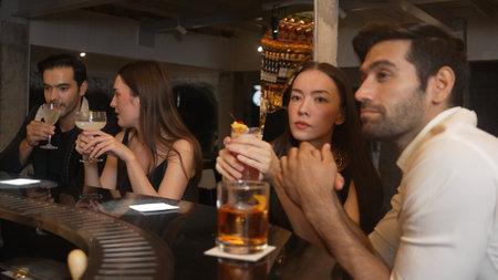 Friends or couple talking and drinking cocktail in Paloma, Margarita, Old fashioned and Martini glass celebrating special party beverage in vibrant nightclub making a toast with friendship. Vinosity.の写真素材