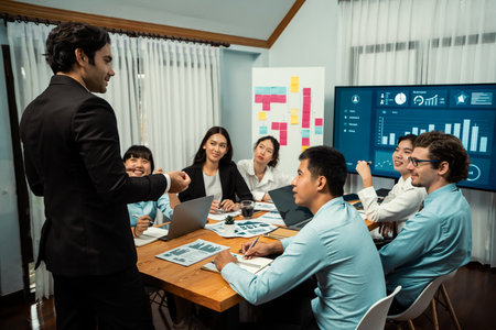 Diverse group of business analyst team analyzing financial data report. Finance data analysis chart and graph dashboard show on TV screen in meeting room for strategic marketing planning. Habilimentの写真素材