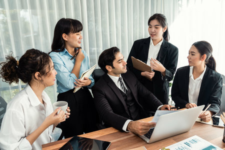 Business professionals working together in modern office environment. Team members engage in discussion for strategic business marketing.の写真素材
