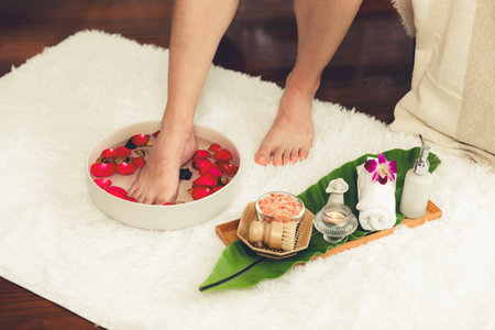 Person indulges in blissful foot massage at luxurious spa salon with reflexology therapy in gentle day light ambiance resort or hotel foot spa. Quiescentの写真素材