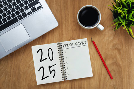 2025 Happy New Year Resolution Goal List and Plans Setting - Business office desk with notebook written about plan listing of new year goals and resolutions setting. Change and elation concept.の写真素材