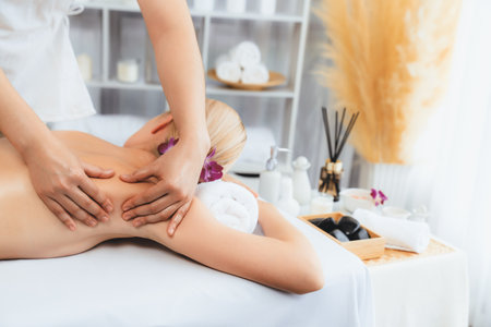 Caucasian woman customer enjoying relaxing anti-stress spa massage and pampering with beauty skin recreation leisure in day light ambient salon spa at luxury resort or hotel. Quiescentの写真素材