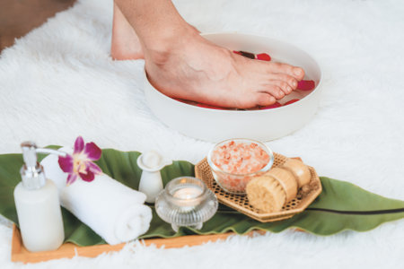 Woman indulges in blissful foot massage at luxurious spa salon while masseur give reflexology therapy in gentle day light ambiance resort or hotel foot spa. Quiescentの写真素材
