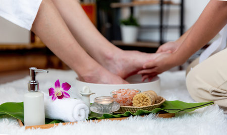 Man indulges in blissful foot massage at luxurious spa salon while masseur give reflexology therapy in gentle day light ambiance resort or hotel foot spa. Quiescentの写真素材