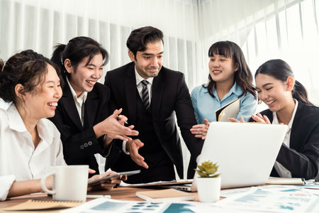 Diverse group of business analyst team analyzing financial data report paper on office table. Chart and graph dashboard by business intelligence analysis for strategic marketing planning Meticulousの写真素材