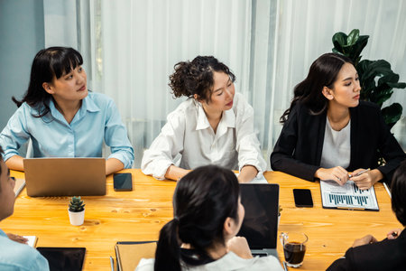 Diverse group of business analyst team analyzing financial data report paper on office table. Chart and graph dashboard by business intelligence analysis for strategic marketing planning Meticulousの写真素材