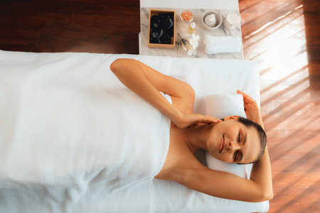 Panorama top view woman customer enjoying relaxing anti-stress spa massage and pampering with beauty skin recreation leisure in day light ambient salon spa at luxury resort or hotel. Quiescentの写真素材