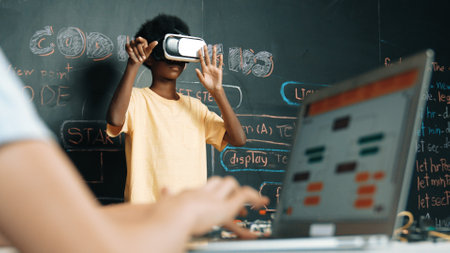 Closeup of school girl hand coding program while african student using VR interact with metaverseworld. Smart boy wearing virtual reality glasses and playing video games at innovative classの写真素材