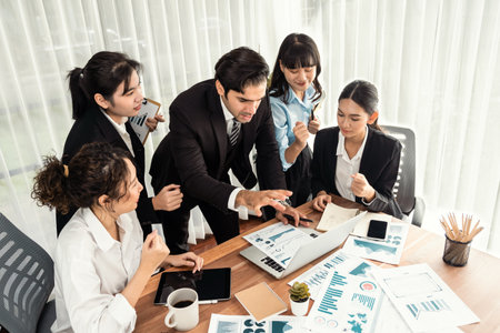 Diverse group of business analyst team analyzing financial data report paper on office table. Chart and graph dashboard by business intelligence analysis for strategic marketing planning Meticulousの写真素材