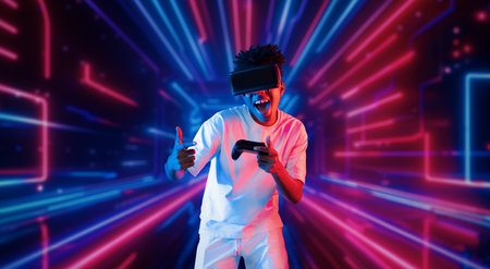 Teenager holding joystick and wearing VR goggles while enjoy playing games at neon abstract...