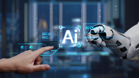A human hand reaches towards a robotic hand displaying AI technology, symbolizing interaction...