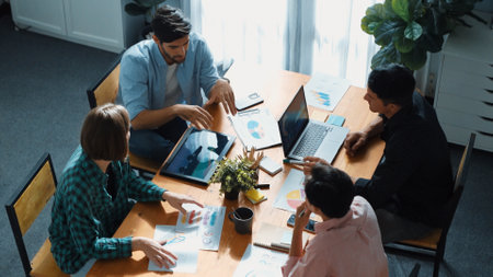 Top view of business people discuss idea while marketing team joining meeting. Manager pointing financial graph while colleagues talking to investor by using phone and brainstorm idea. Convocation.の写真素材